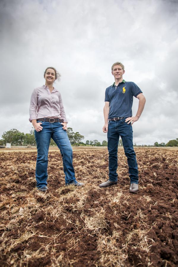 Two young students standing in a fallow paddock