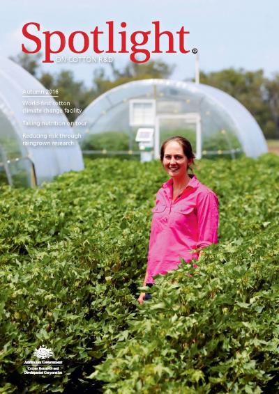 Cover of Spotlight Magazine - Autumn 2016. A researcher in a pink shirt standing in a cotton trial paddock. In the background are cotton glasshouses